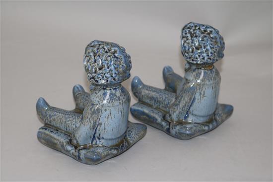 A pair of Clarice Cliff golly blue mottle glazed bookends, height 15.5cm, one damaged